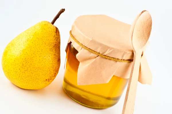Honey in jar and pear. — Stock Photo, Image