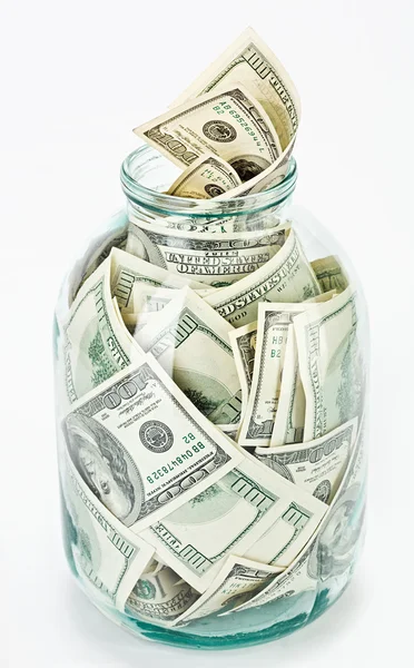 Muchos 100 dólares estadounidenses en un frasco de vidrio —  Fotos de Stock