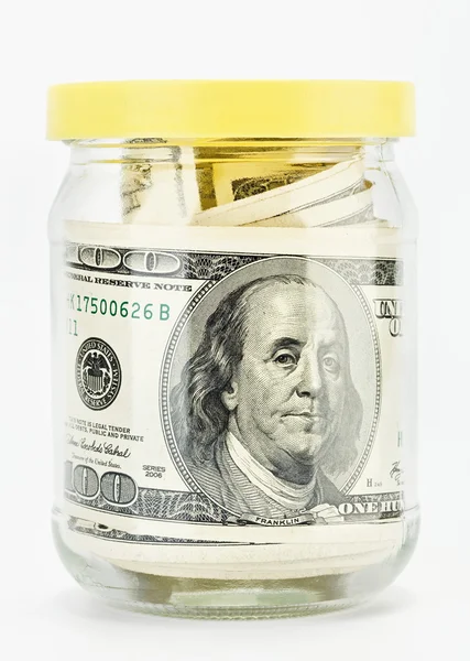 Muchos 100 dólares estadounidenses en un frasco de vidrio —  Fotos de Stock