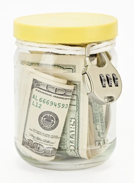 Many 100 US dollars in a glass jar — Stock Photo, Image