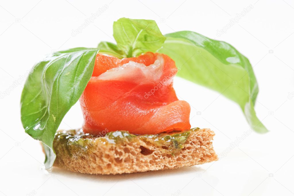 Salmon canape with basil isolated on white