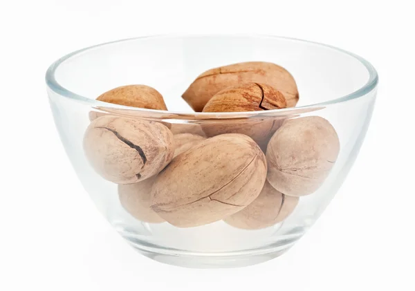 Pecan nuts in a glass bowl isolated on white — Stock Photo, Image