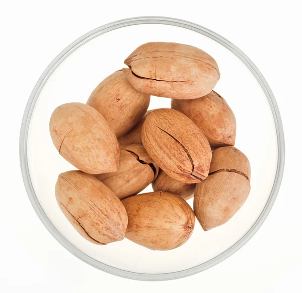 Pecan nuts in a glass bowl isolated on white — Stock Photo, Image