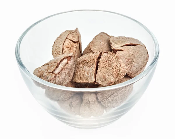 Brazil nuts in a glass bowl isolated on white — Stock Photo, Image