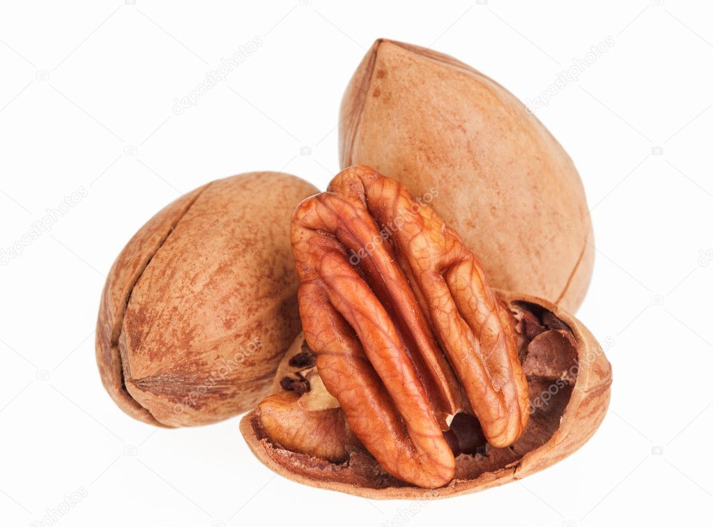 Few pecan nuts isolated on white, one cracked