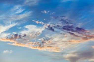 Cumulus clouds on sunset sky background clipart