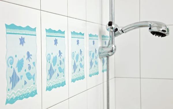 Blue bathroom ceramics tile and metal shower tap — Stock Photo, Image