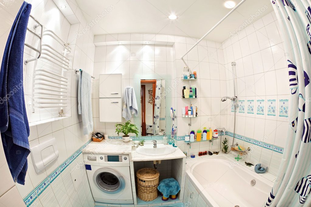 Modern small bathroom in blue colors wide angle view