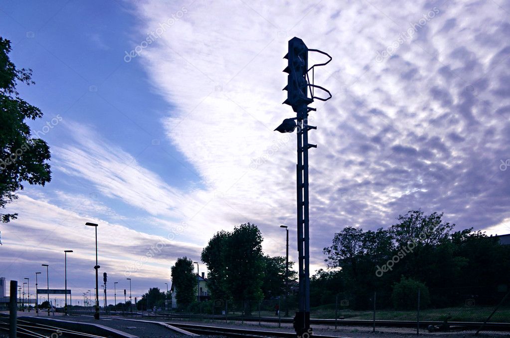 Semaphore on railway station in front of dramatic fleecy clouds