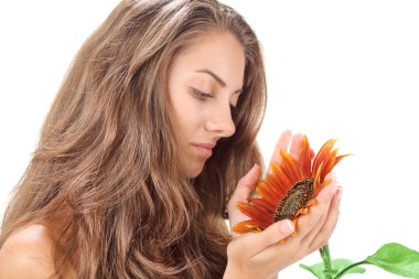 Young beautiful woman with long hairs holding sunflower near fac clipart