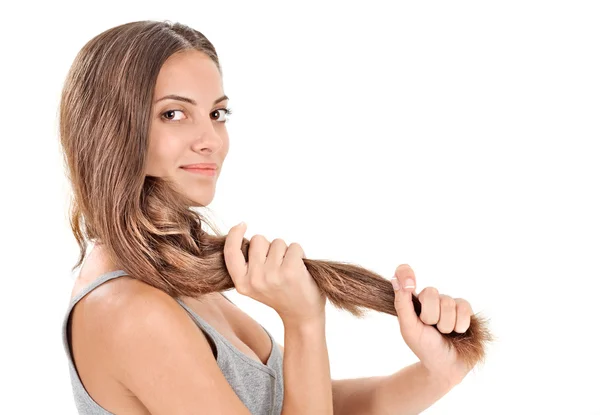 Young brunette beautiful lady playing with long hairs on white — Stock Photo, Image