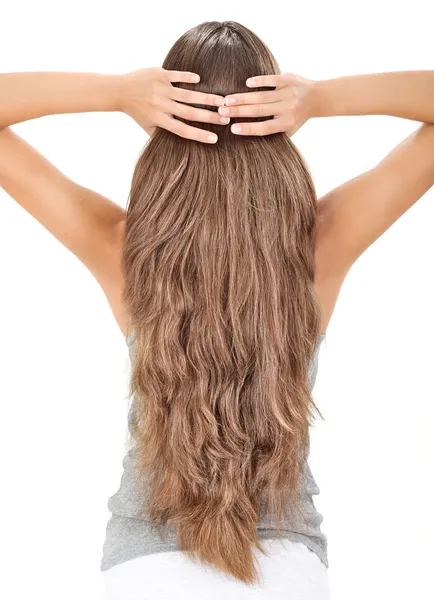 Brunette lady holding long hairs, view from back side isolated o — Stock Photo, Image