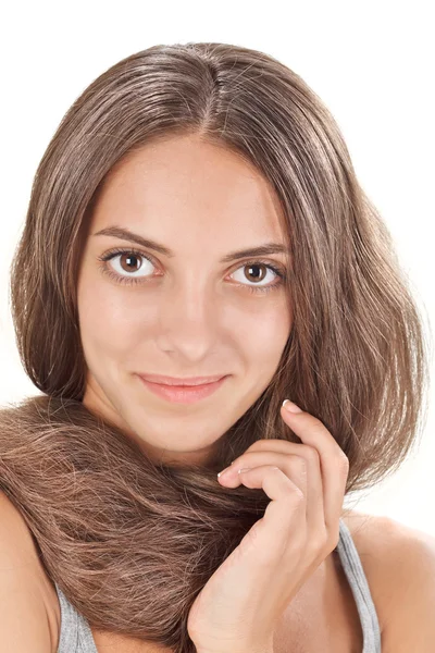 Face studio portrait of young lady with long hairs twisted round — Stock Photo, Image