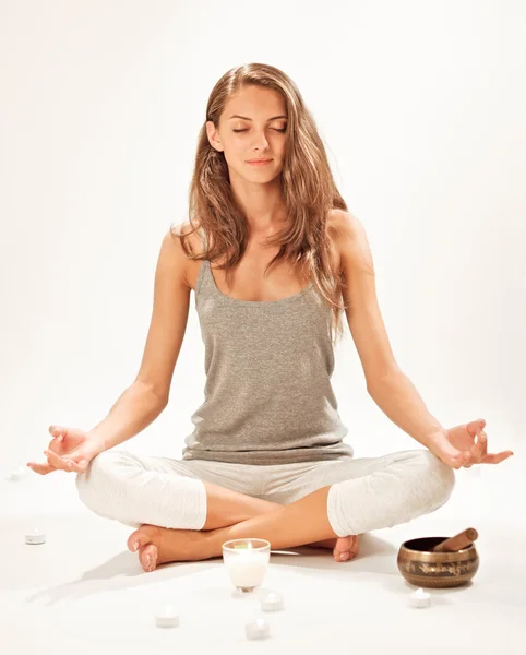 Young beautiful woman meditating in lotus pose — Stock Photo, Image