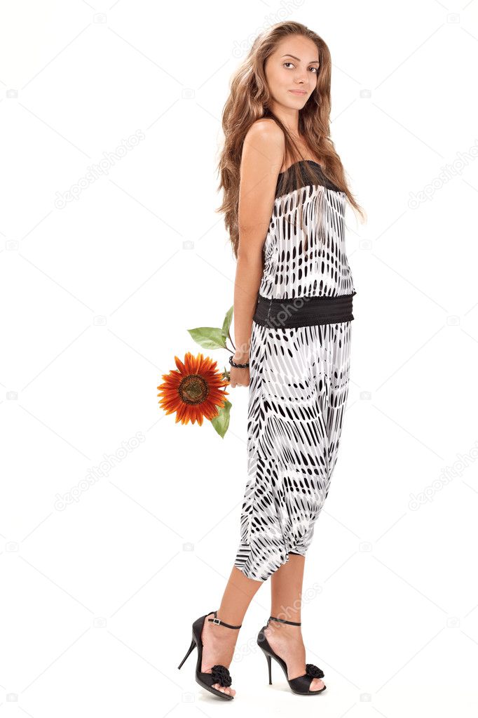 Young beautiful lady in harem pants with sunflower full-length s