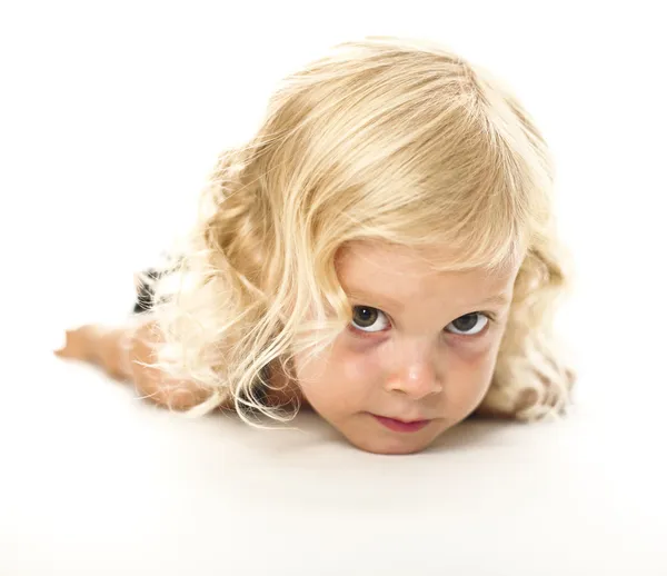 Funny lay down blonde kid — Stock Photo, Image