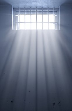 Cold prison cell with sunshine through window clipart