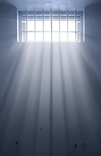 Cold prison cell with sunshine through window — Stock Vector
