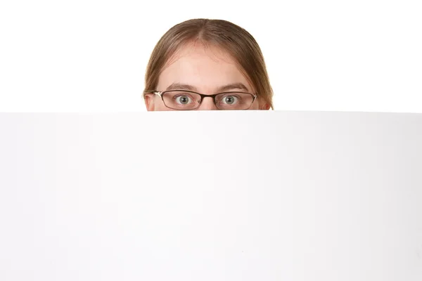 Business woman peering over white sign — Stock Photo, Image