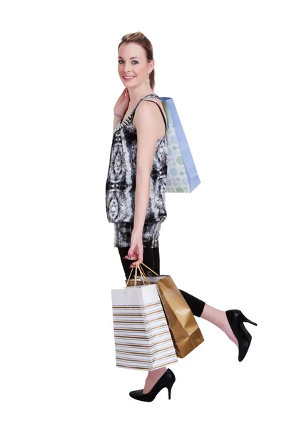 Giovane donna con shopping bags su bianco — Foto Stock