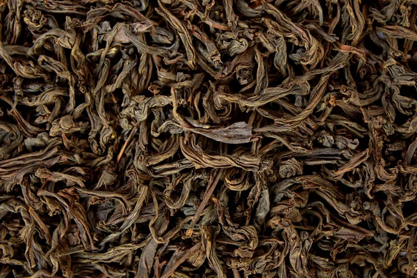 Black tea background — Stock Photo, Image