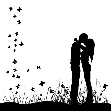 Couple kisses on a meadow