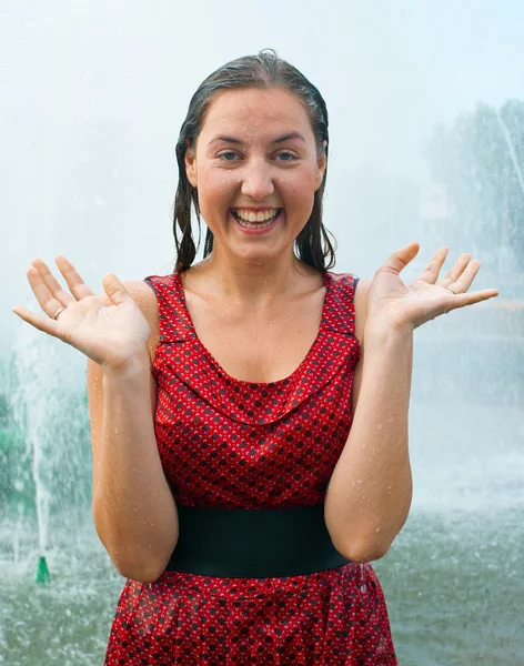 Laughing girl in wet clothes