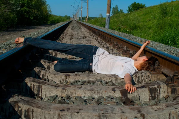 Girl laying on a railway — Stock Photo, Image