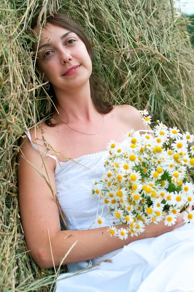 Beautiful girl on haystack — Stock Photo, Image