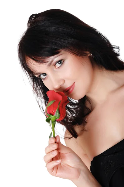 Jonge mooie brunette met een mooie rode roos — Stockfoto