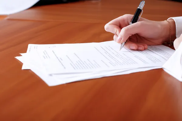 Person's hand signing document Royalty Free Stock Photos