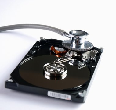 Computer hard drive and a stethoscope. clipart