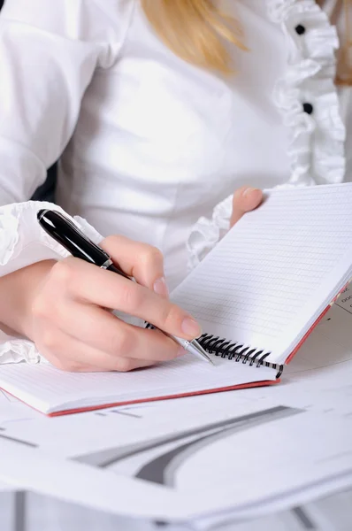 Hand of a young business woman working with documents — Stock Photo, Image