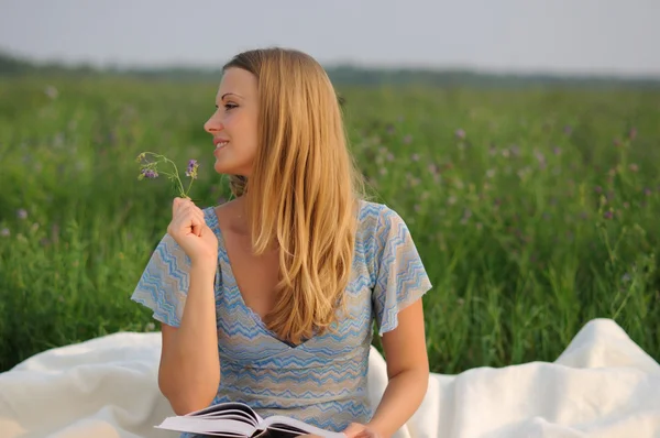 Yeşil çimenlerin üzerinde oturan kız — Stok fotoğraf