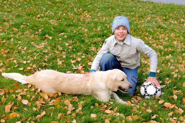 Pojke spelar i höst park — Stockfoto