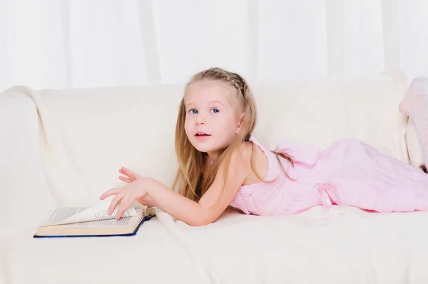 Little girl lying on the couch — Stock Photo, Image