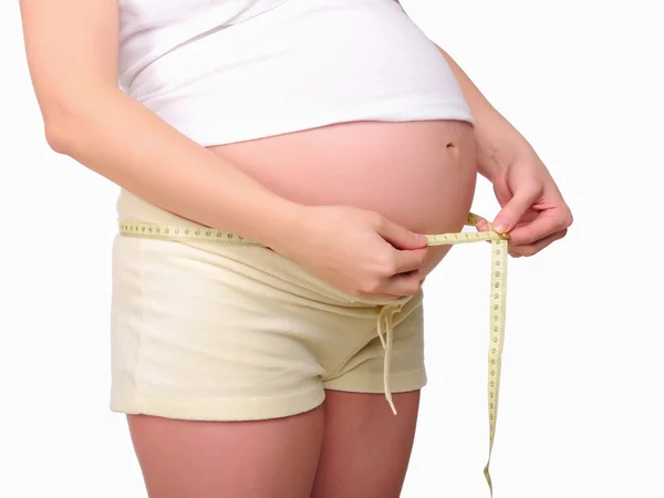 stock image Young pregnant mom measure