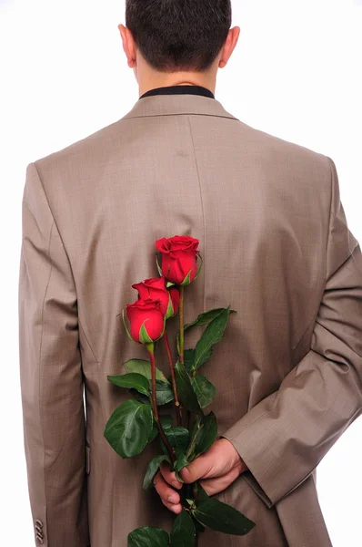 Un jeune homme se cache derrière une rose — Photo