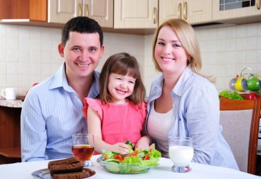 Dad, Mom and their little daughter clipart