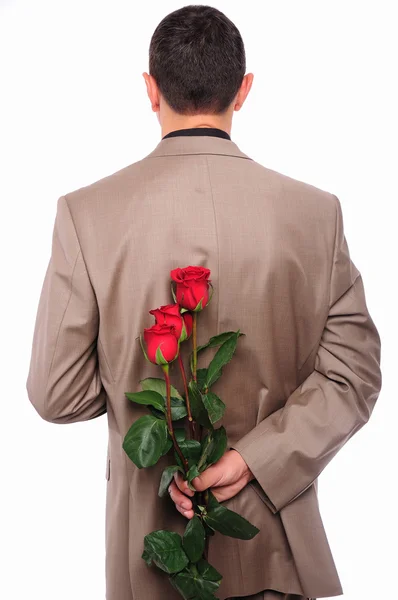 Jovem se esconde atrás de uma rosa — Fotografia de Stock