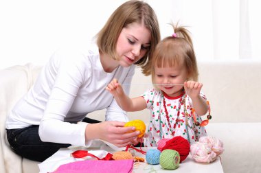 Young mother and her baby daughter clipart