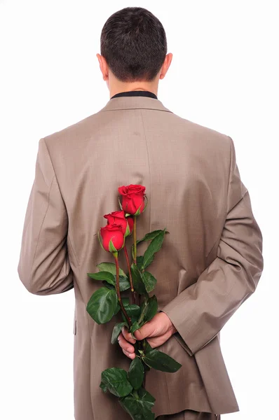 Młody człowiek chowa się za różę — Zdjęcie stockowe