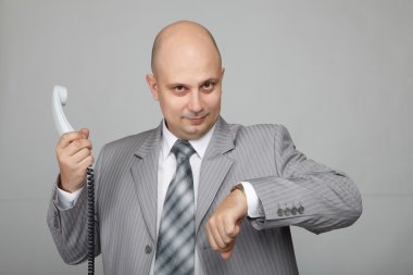 Bald businessman with the handset clipart