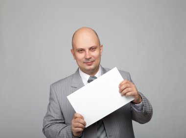 Bald businessman in a gray suit