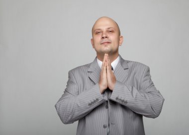 Bald businessman in a gray suit