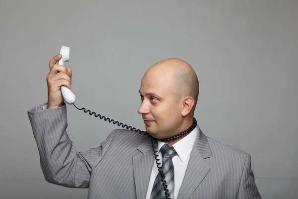 Bald businessman with the handset — Stock Photo, Image