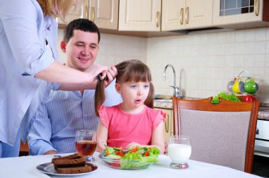 Dad, Mom and their little daughter clipart