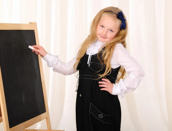 Little girl wrote a white chalk — Stock Photo, Image
