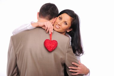 Young girl hugs her man and holding a red heart clipart