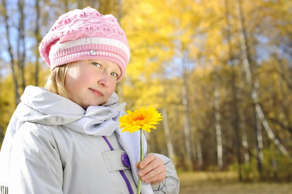 Little girl with a yellow flower — Stock Photo, Image